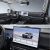 Interior of a car featuring a digital dashboard and a large central touchscreen displaying a vehicle image.