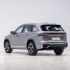 Rear side view of a silver Geely SUV.