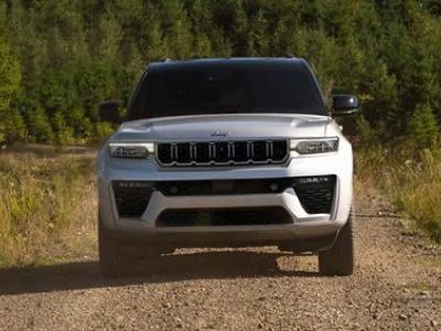 A gray 2026 Jeep Grand Cherokee L Summit traveling down a coastal highway