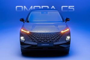 Front view of the black Omoda C5 car with its headlights on, set against a blue background with "OMODA C5" text.