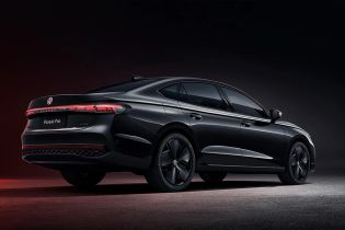 Rear side view of a black Volkswagen Passat Pro sedan.
