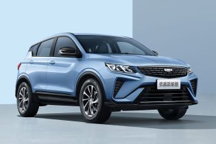 A light blue Geely SUV in a studio setting.