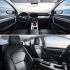 Interior of a car, showing the dashboard, front seats, and a spacious, modern design with a view of the sky through the windows.