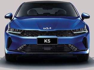 Front view of a blue Kia K5 sedan, highlighting its sleek headlight design, black grille, and "K5" badging, embodying a sporty and modern aesthetic.