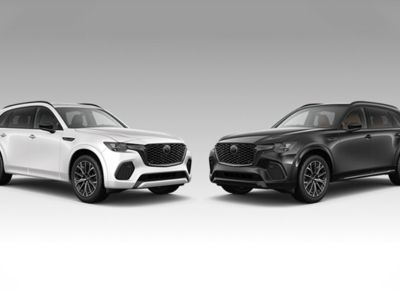 Side-by-side view of a 2025 Mazda CX-70 against a CX-90 background, showcasing contrasting color options