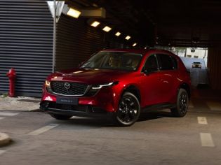 Red Mazda CX-5 SUV parked in dim underground parking lot