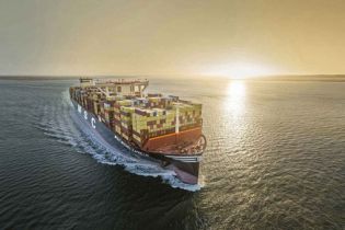 A large MSC container ship sailing on the sea during sunset.