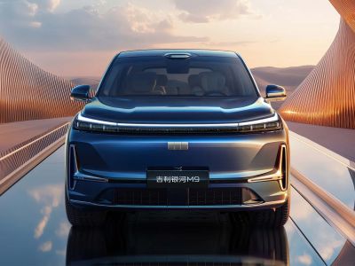 Front view of Geely Galaxy M9, a sleek blue SUV, on a reflective road with an artistic, modern background under a sky with clouds.