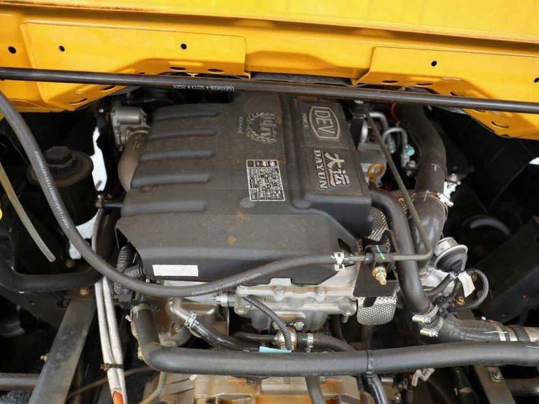 Close - up of a Dayun vehicle engine compartment with hoses and components.