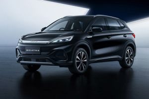 Sleek black BYD ATTO 3 electric SUV showcased in a modern, minimalist studio setting with a reflective dark floor.