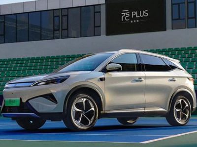 A light - colored BYD Yuan Plus electric SUV parked on a tennis court.