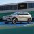 A light - colored BYD Yuan Plus electric SUV parked on a tennis court.