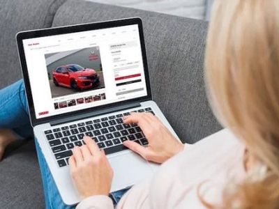 Browse cars online using a laptop