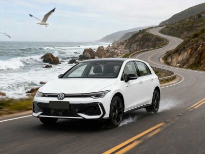 A white Volkswagen hatchback with a sleek design.