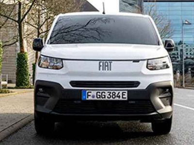 Front view of a white Fiat van with license plate F GG 384E, parked on a street in an urban area.