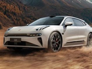 A white Zeekr 001 driving on a dusty terrain, with a backdrop of autumn forests and mountains, showcasing its dynamic off-road performance and sleek design.