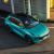 A turquoise Forthing T5 EVO SUV with a black roof, captured in an overhead view, parked on a paved area near a modern building, highlighting its sleek and dynamic design.