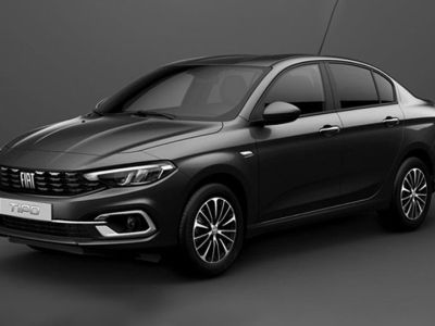 The Fiat Tipo sedan, in a sleek dark gray finish, showcases its refined design with modern headlights and stylish alloy wheels, embodying Fiat's blend of practicality and contemporary aesthetics.