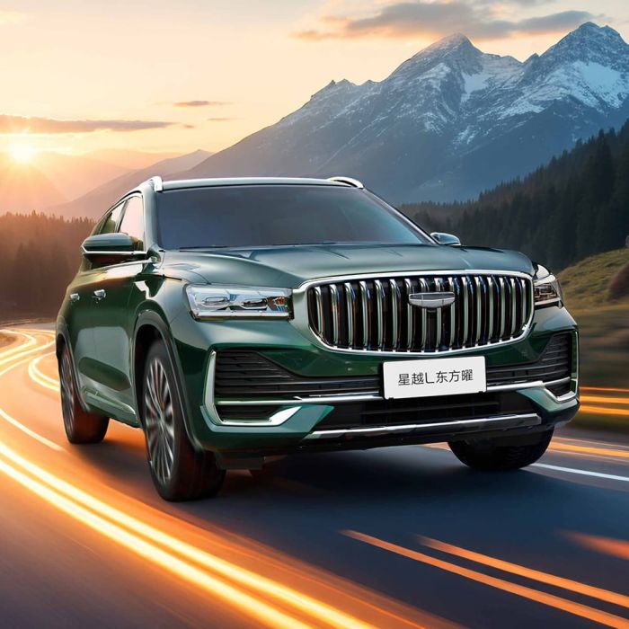Geely Xingyue L SUV driving on a road with a mountainous sunset background.