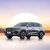 Geely Xingyue L SUV with a sunset and mountain background.