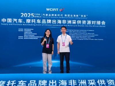 Two people posing at the Supply and Purchase Matchmaking Event of Chinese Automotive and Motorcycle Brands into the African Market.