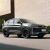 Geely BinYue L SUV parked on the street beside a concrete building.