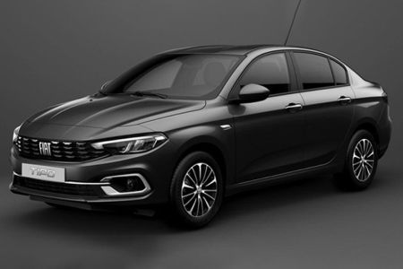 The Fiat Tipo sedan, in a sleek dark gray finish, showcases its refined design with modern headlights and stylish alloy wheels, embodying Fiat's blend of practicality and contemporary aesthetics.
