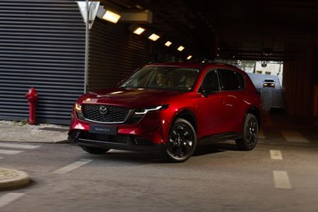 Red Mazda CX-5 SUV parked in dim underground parking lot
