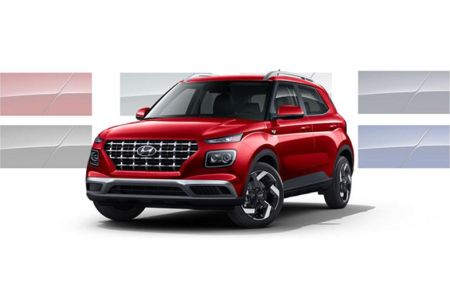 Three-quarter view of the front side of a red 2026 Hyundai Venue