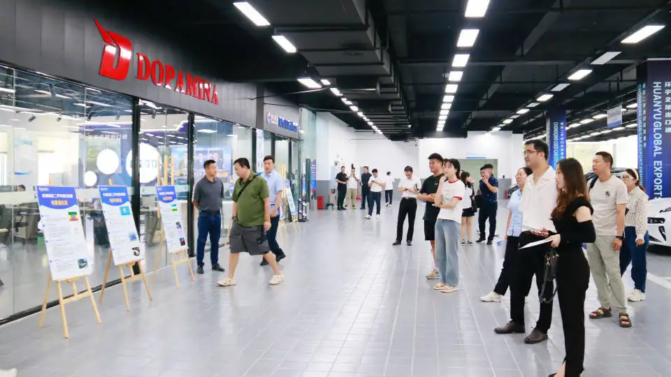 People visiting a modern exhibition space with the "DOPAMINA" sign and display boards.