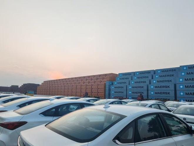Cars exported from China are being crated at the port