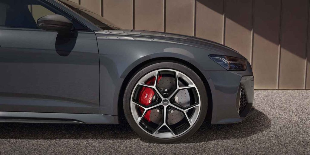 Close - up of an Audi car's wheel and brake system, showcasing its sporty design with red brake calipers.