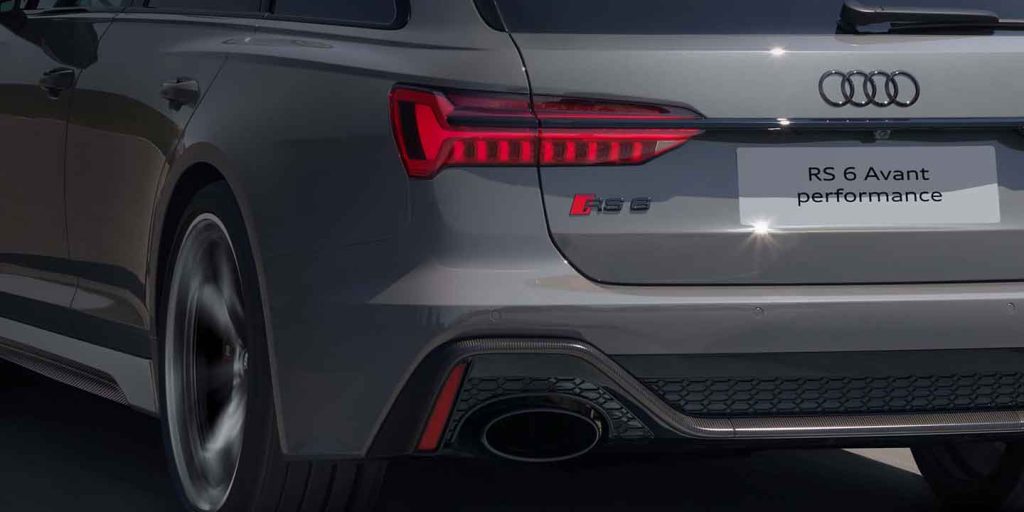 The rear part of the Audi RS 6 Avant performance, showcasing its distinctive taillights, badges and exhaust design.