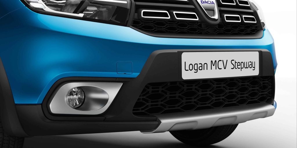 Close - up of the front bumper and fog light of a blue Dacia Logan MCV Stepway.