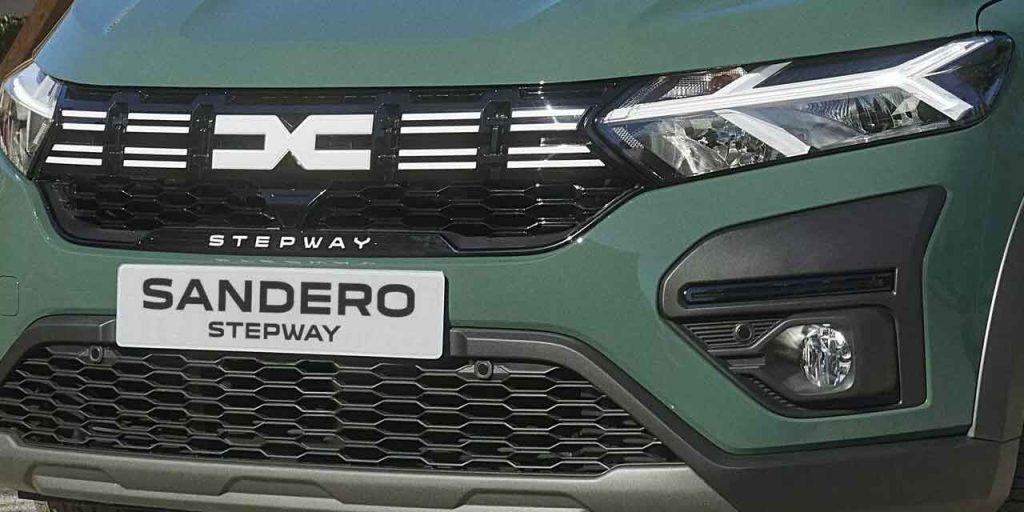 Close - up of the front grille and headlights of a green Dacia Sandero Stepway.