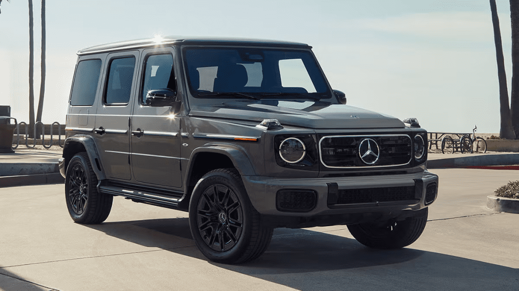 A gray Mercedes-Benz G-Class SUV parked on a sunny street.