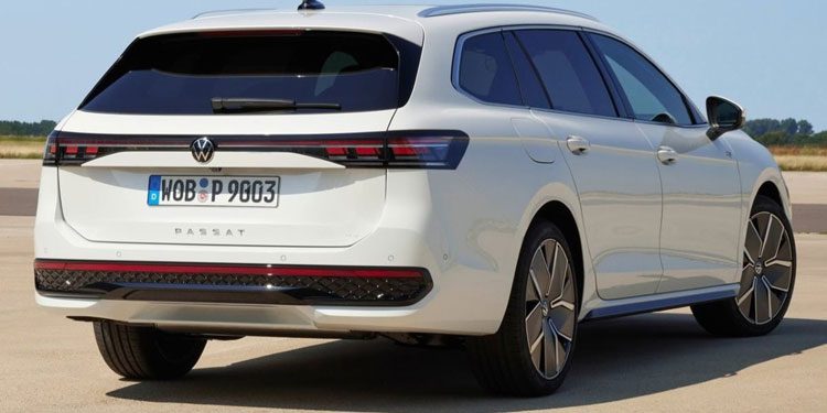 Rear view of a white Volkswagen Passat wagon: Features LED taillights, alloy wheels, and "PASSAT" badging. License plate "WOB P 9803" visible, set against an open, sunny background.