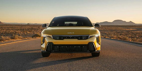 2026 Kia K4 Hatchback, parked in the middle of a desert road at golden hour, front-view