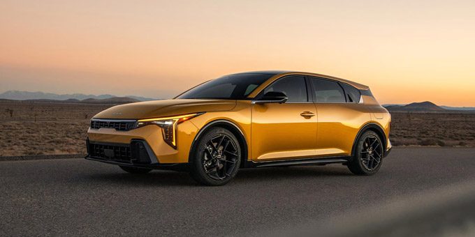 2026 Kia K4 Hatchback, parked on a desert road at sunset, front three-quarter view
