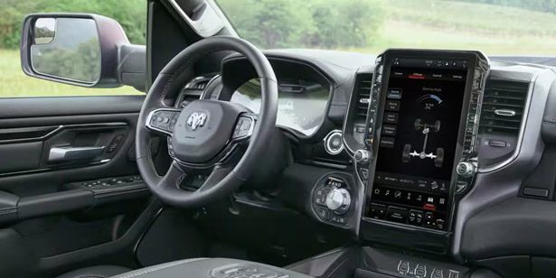 Display The steering wheel and very large Uconnect touchscreen in the 2026 Ram 1500 Rebel.