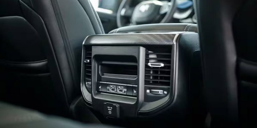 Display The rear seat climate controls, USB ports and cubby bin on the back of the center console in the 2026 Ram 1500 Rebel