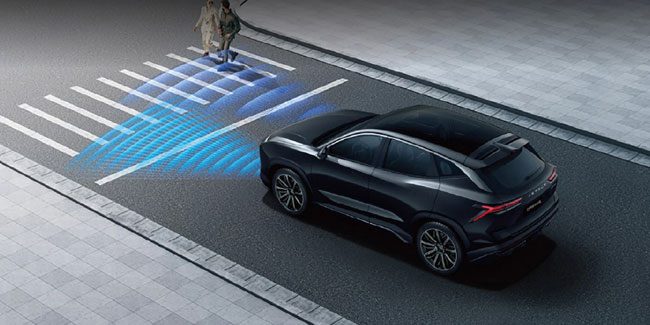 A black SUV uses blue sensor waves to detect two pedestrians crossing a road at a crosswalk.