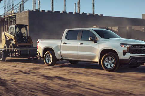 2026 Chevrolet Silverado LD Crew Cab WT towing a trailer on a construction site