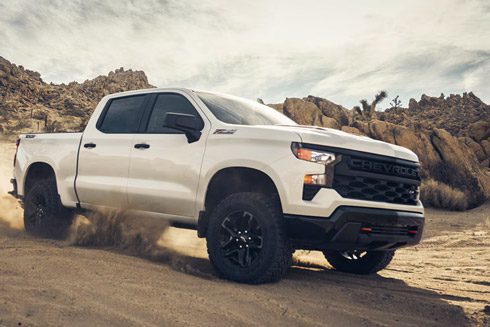 2026 Chevrolet Silverado LD Trail Boss driving on a sandy terrain