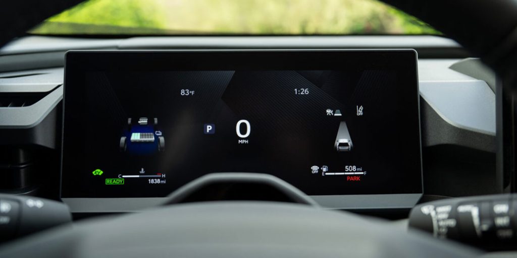Modern car digital dashboard display showing speed, gear status, vehicle graphics, and range metrics against a sleek black interface.