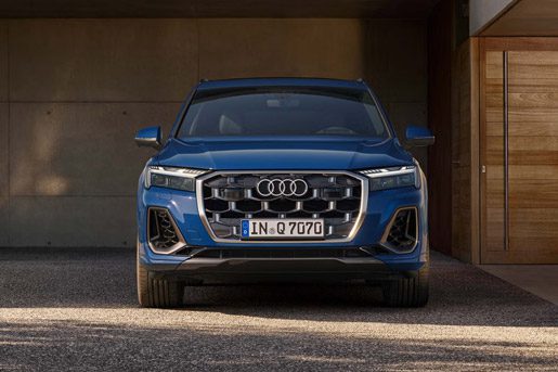 Audi Q7 front view: Striking blue luxury SUV with signature octagonal grille, sleek LED headlights, and bold front fascia.