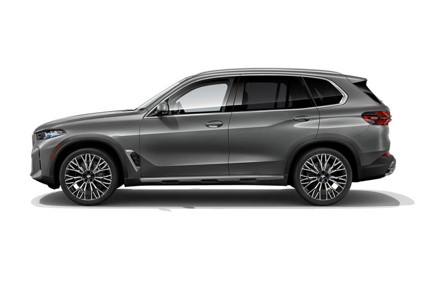 BMW X5 side profile: Sleek gray luxury SUV with sculpted body lines, 22-inch multi-spoke alloy wheels, and a panoramic sunroof.