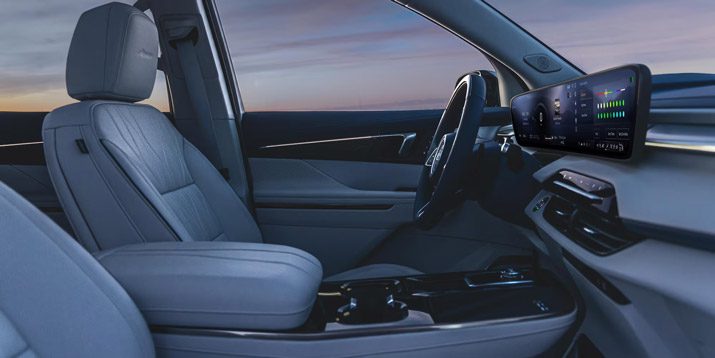 Premium Buick interior: Light gray leather seats, curved digital display, and a sleek, modern dashboard design.