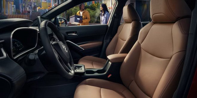 Toyota interior: Premium tan leather seats and a modern black dashboard, ideal for urban driving.
