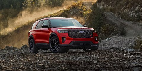 A 2026 Ford Explorer ST SUV parked on a rocky expanse near a mountain